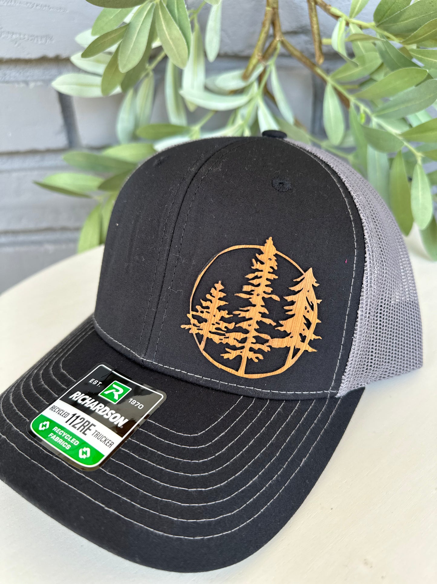 Trucker hat with 3 trees leather patch