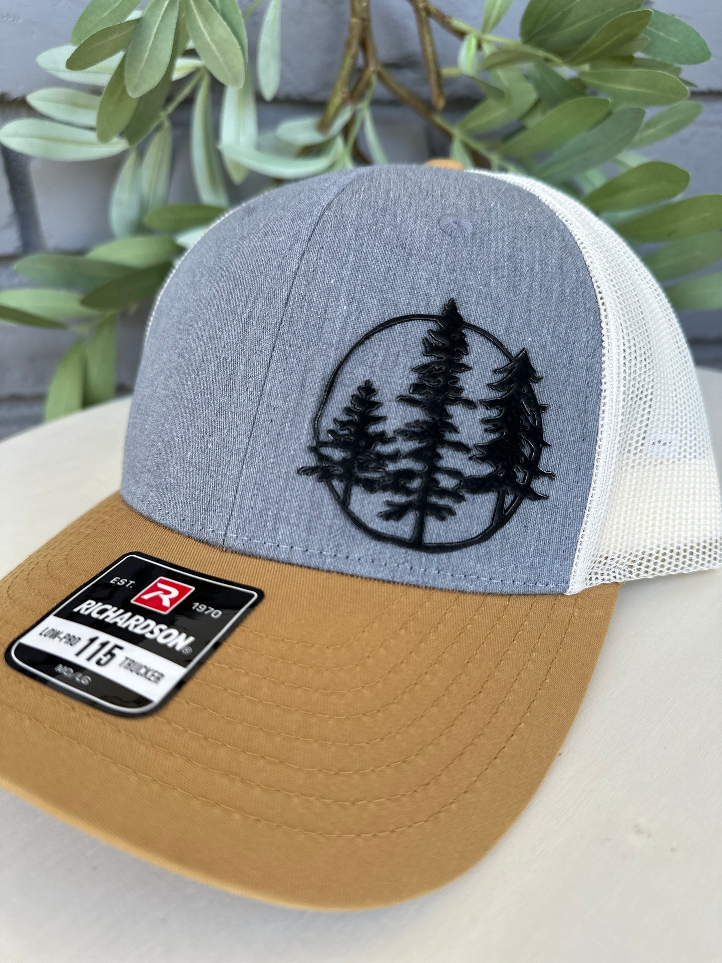 Trucker hat with 3 trees leather patch